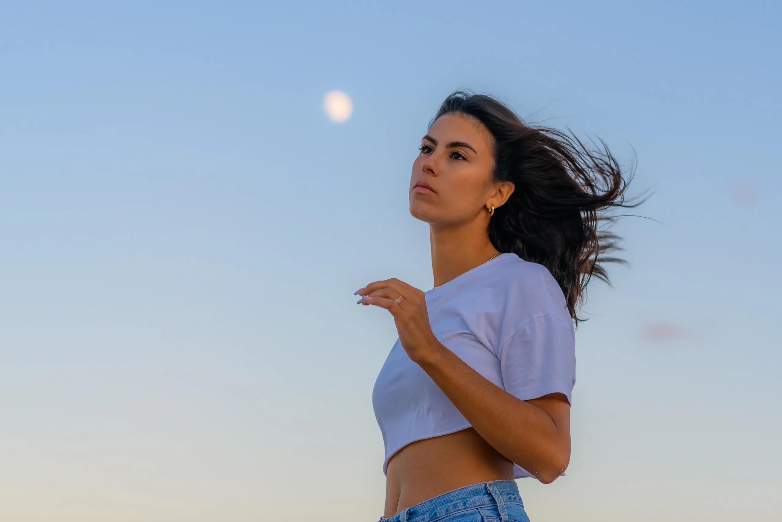 Portrait of Eline, her hair blowing in the wind beneath the moon
